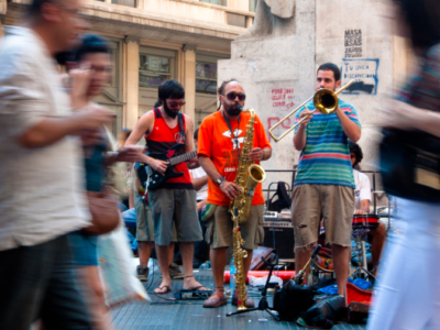 Musicians playing on a busy city street.