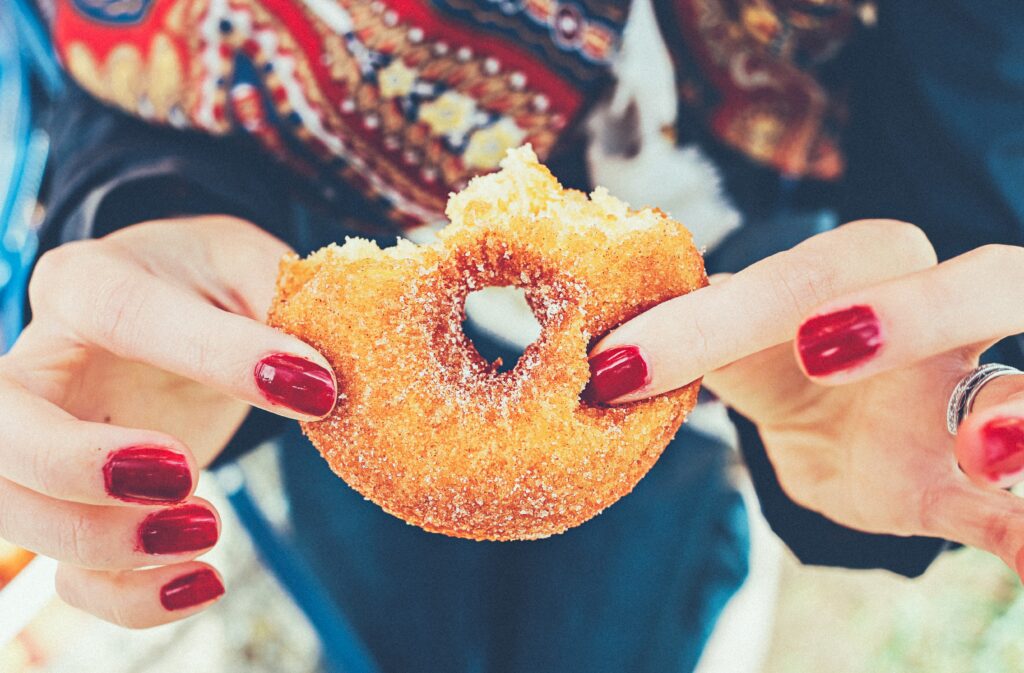 Image of a hand holding a doughnut