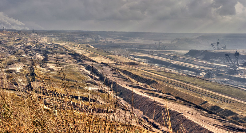 smoky, brown open coal mine