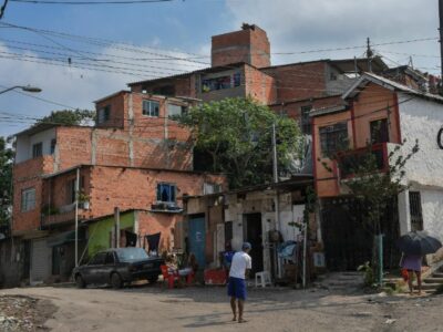 View of the main entrance of Vila Nova Esperanca, a 'green favela' that utilizes the principles of permaculture and fights to be a model of sustainable living (Sao Paulo, Brazil - Feb 2020) Credit: Nelson Almeida - sustainable housing