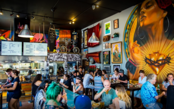 Patrons dine inside ¡Salud Tacos!, a " hip, casual Mexican eatery" located in San Diego, CA.