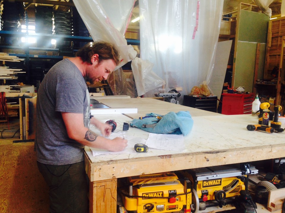 just transition: Wood Shop partner Maxim Piche works in the co-op's collaborative space. Credit: Amy Logan for VIA 