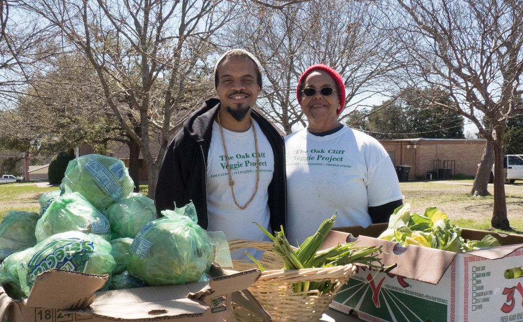 Bettie Montgomery poses with her son Ples, both members of the Oak Cliff Veggie Project. They distribute free produce in front of the Singing Hills Community Garden. Credit: Danny Fulgencio