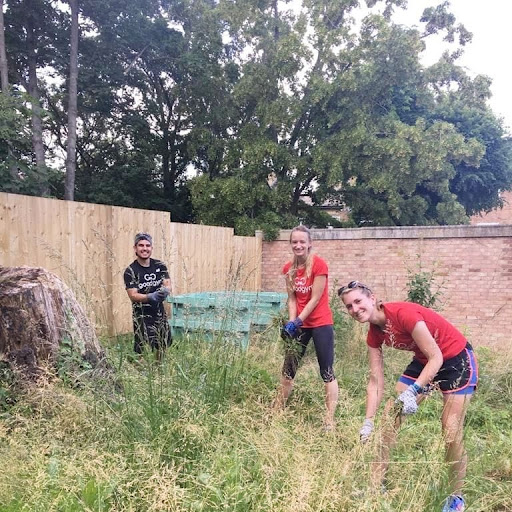 Ellie, Sophie and Sam completed a run to London's St. Clement Orchard to clear a patch of overgrown grass and weeds. Credit: GoodGym