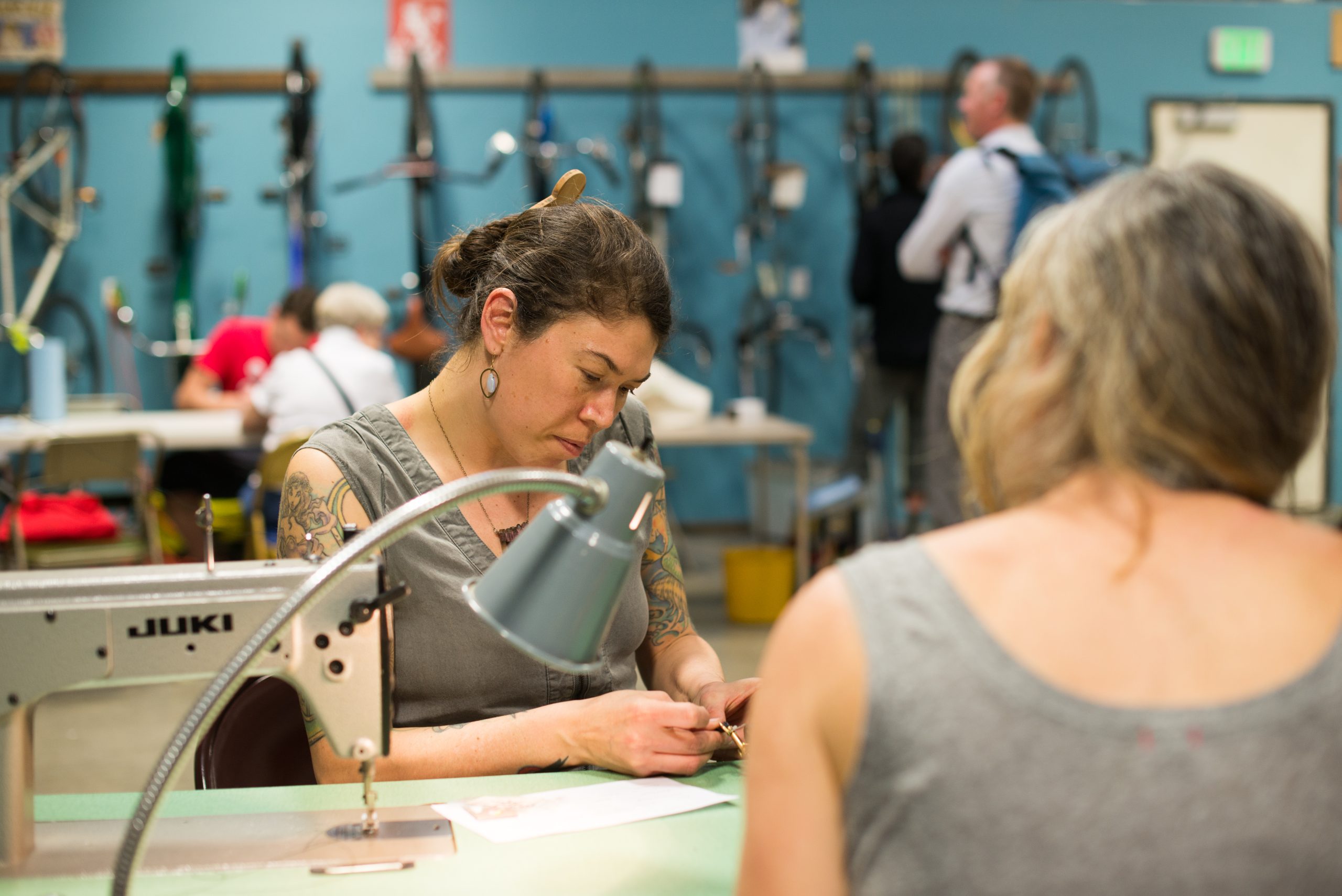 Portland's circular economy. Repair cafes (like the one pictured) are community gathering where people work on repairing objects of everyday life such as electrical and mechanical devices, computers, bicycles, clothing, and other items. Credit: Portland Bureau of Planning and Sustainability