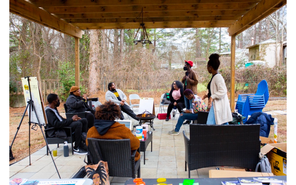 Members of Endstate ATL gather for a community meeting. ESA is one faction of a growing collective of Black Atlantan movement builders championing collective liberation through (among other strategies) solidarity economics. Credit: Endstate ATL