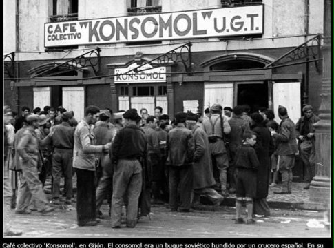 Villagers gather around a collectivized café in Gijon, Spain during the Spanish Civil War