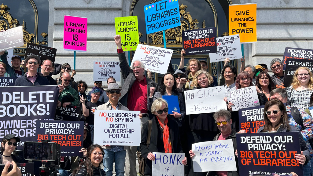 Supporters surround Internet Archive founder Brewster Kahle and San Francisco District 1 Supervisor Connie Chan on the steps of San Francisco City Hall.